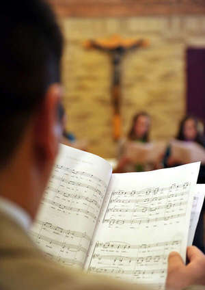 Msm Choir Member Reads Sheet Music During Rehersal